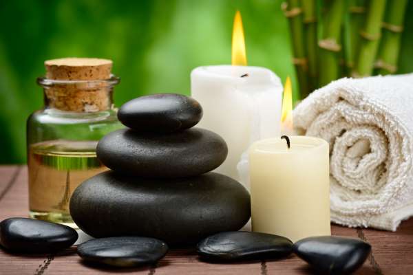 spa concept zen basalt stones and massage oil on the wooden mat