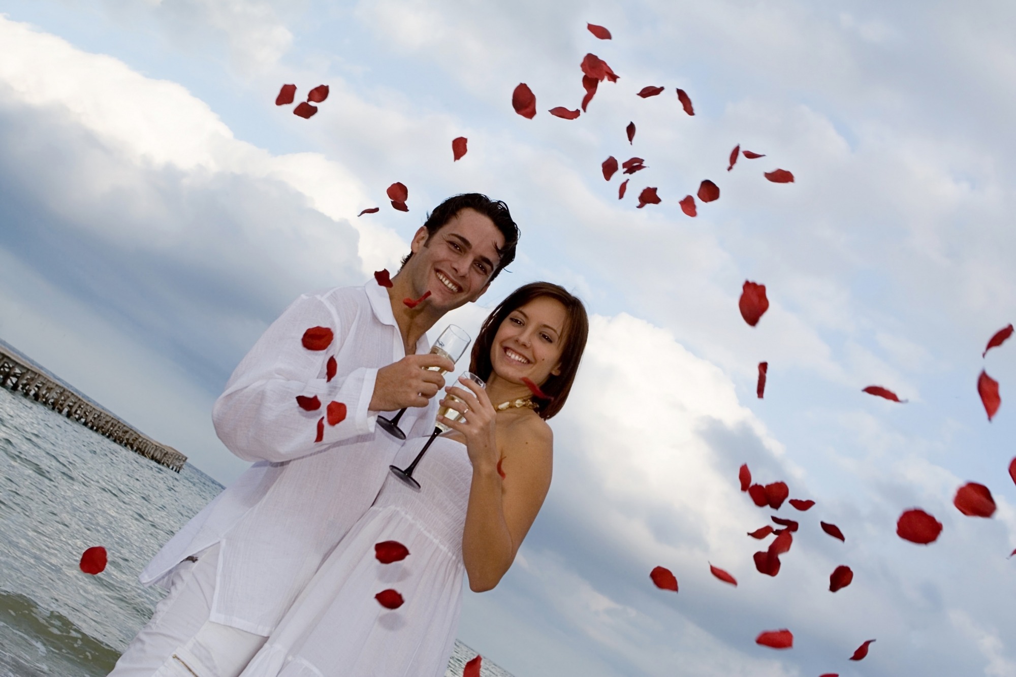 summer outdoor Wedding on beach with rose petal confetti summer outdoor Wedding on beach with rose petal confetti